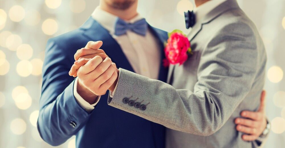 Two men enjoy a dance at their wedding