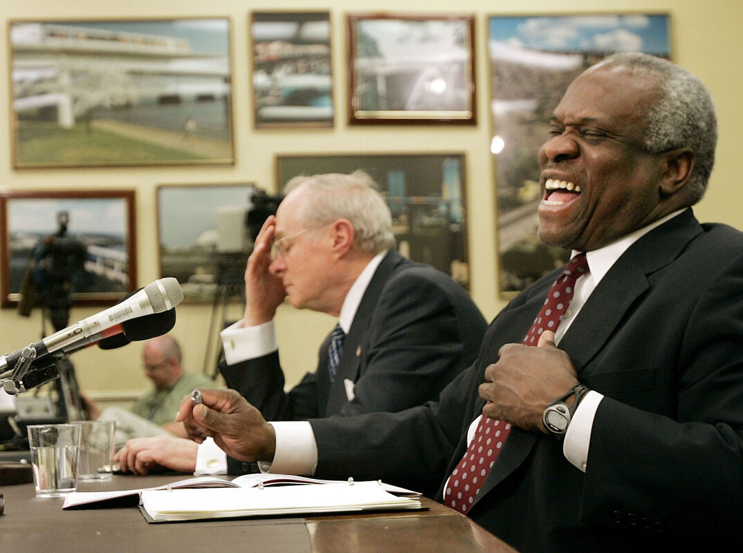 WASHINGTON - APRIL 12: Supreme Court Justice Clarence Thomas (R) laughs as fellow Supreme Court Justice Anthony Kennedy (L) finishes telling a joke during an appearance before a subcommittee of the House Appropriations Committee April 12, 2005 on Capitol Hill in Washington, DC. The two justices appeared before the committee to discuss the Supreme Court's 2006 budget requests. (Photo by Win McNamee/Getty Images)