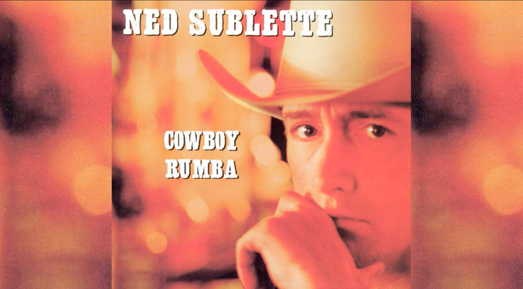 The album cover for Ned Sublette's "Cowboy Rumba" album, featuring the singer looking into the camera mysteriously in a large white cowboy hat.