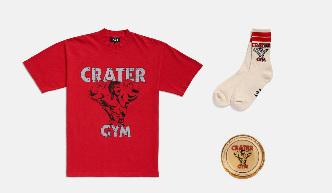 A red t-shirt reading "Crater Gym" with a flexing man, tube socks with red stripes, and an ashtray reading "Crater Gym" as part of A24's "Love Lies Bleeding" merch collection.