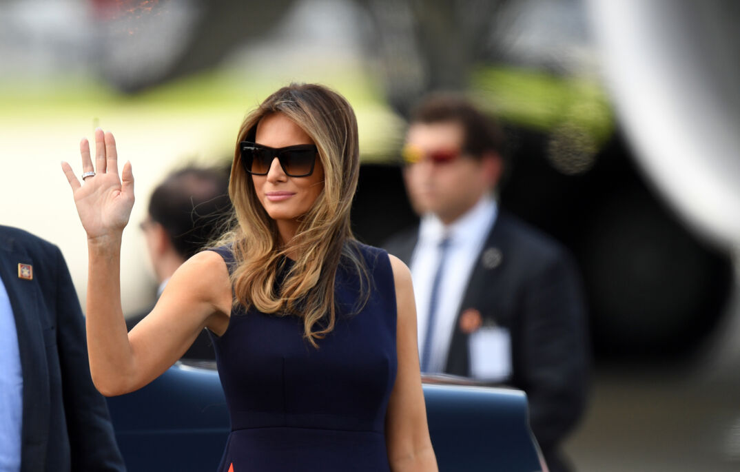 Melania Trump wearing sunglasses and waving