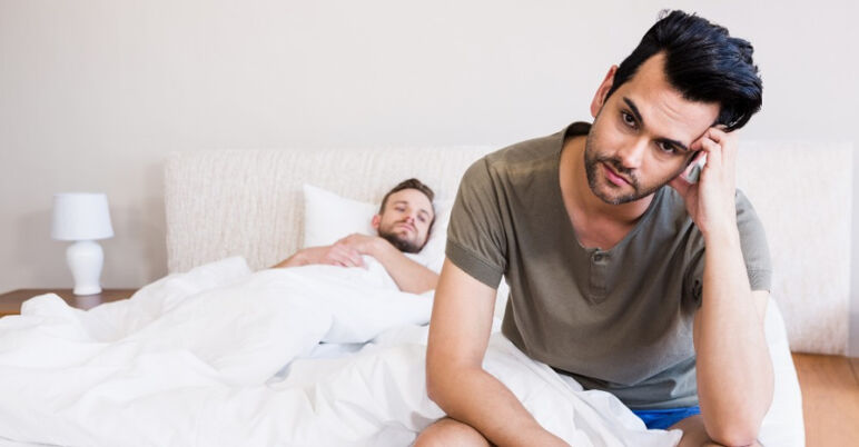 Two gay men in bed