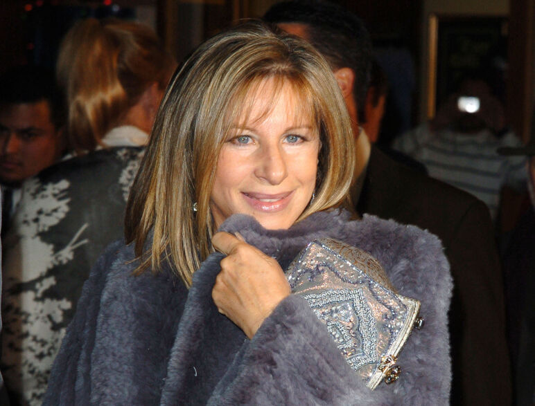 Barbra Streisand smiles in a fuzzy purple coat at the 2004 'Meet the Fockers' premiere.