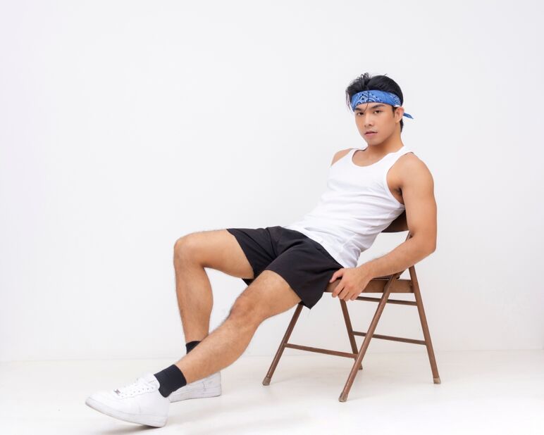 Model in shorts lounging on chair