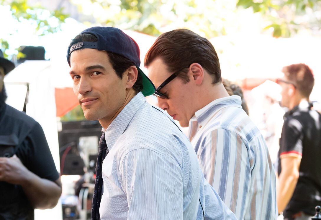 Paul Kelly wears a backward baseball hat on the set of "American Love Story," portraying JFK Jr.