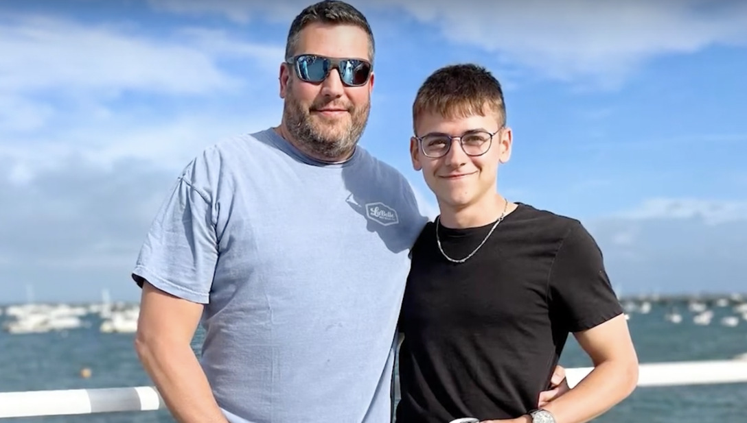 Bret LaBelle wears sunglasses posing next to Chris Stanley on a dock in Provincetown. 