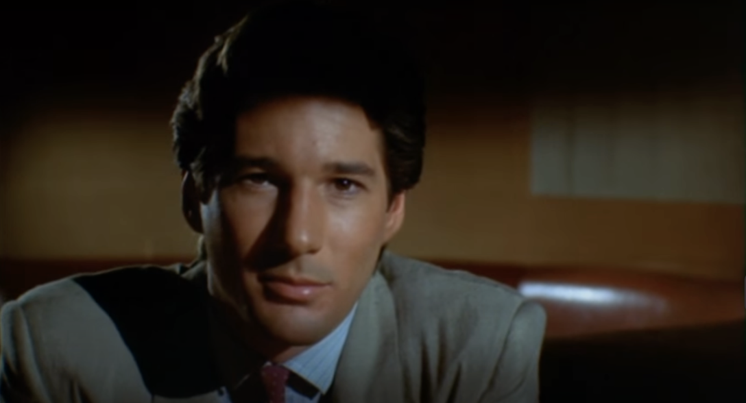 Richard Gere wears a suit and stares intimately at the camera in a scene from "American Gigolo."